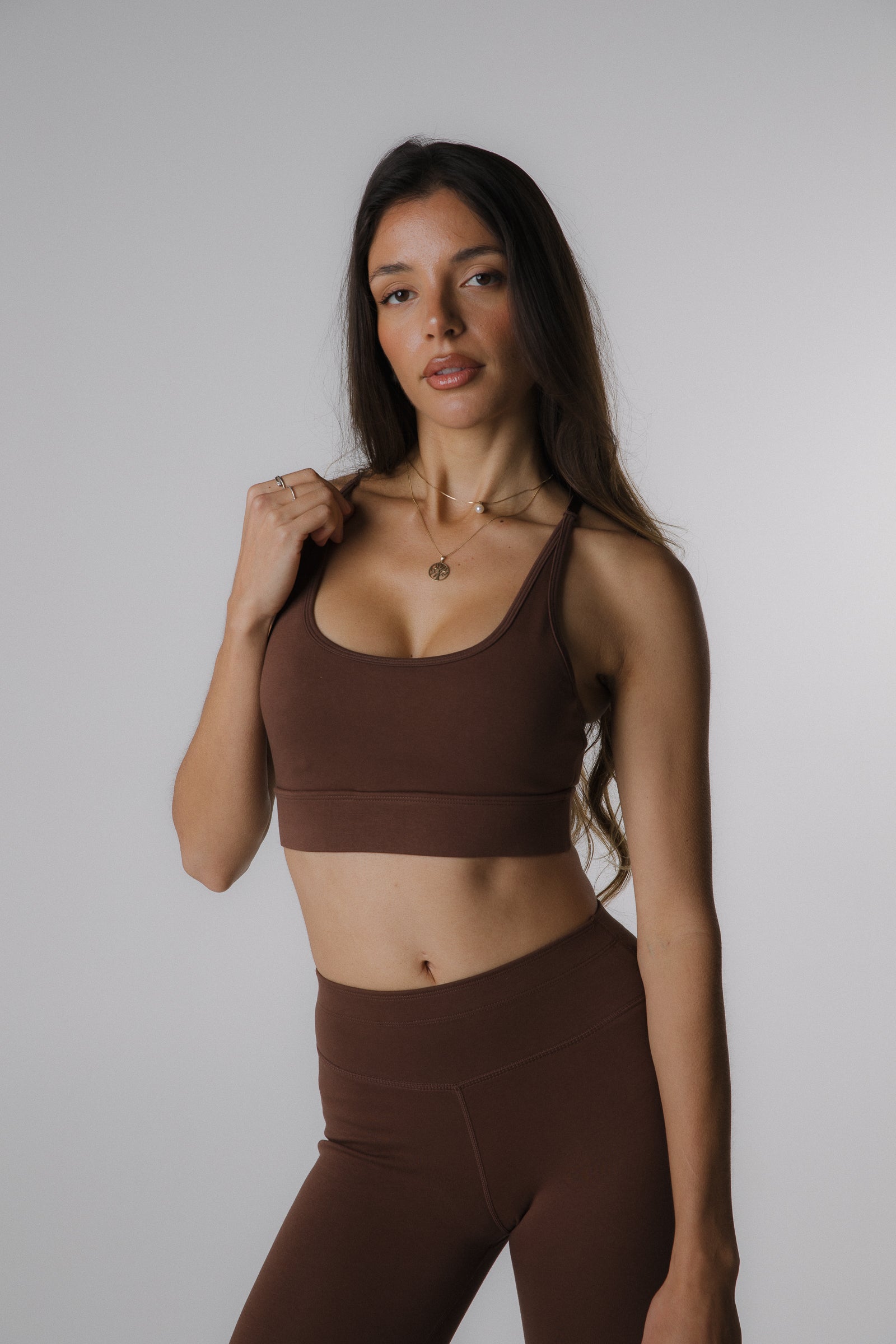 Woman wearing cotton performance sports bra in brown, front view