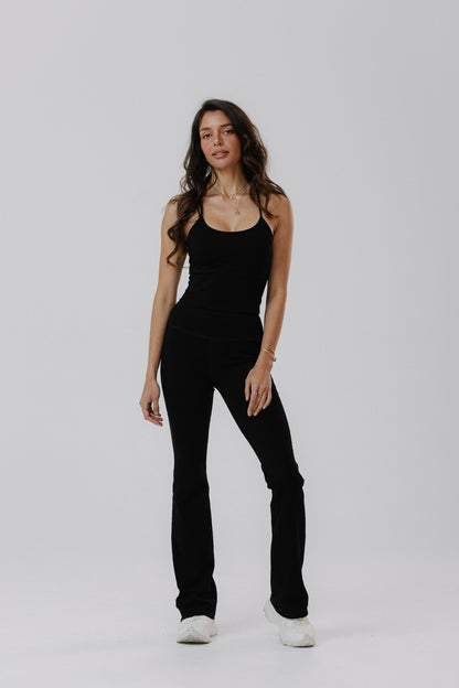 A woman modelling a black cotton tank with built in cups