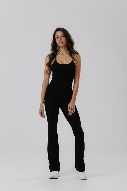 A woman modelling a black cotton tank with built in cups